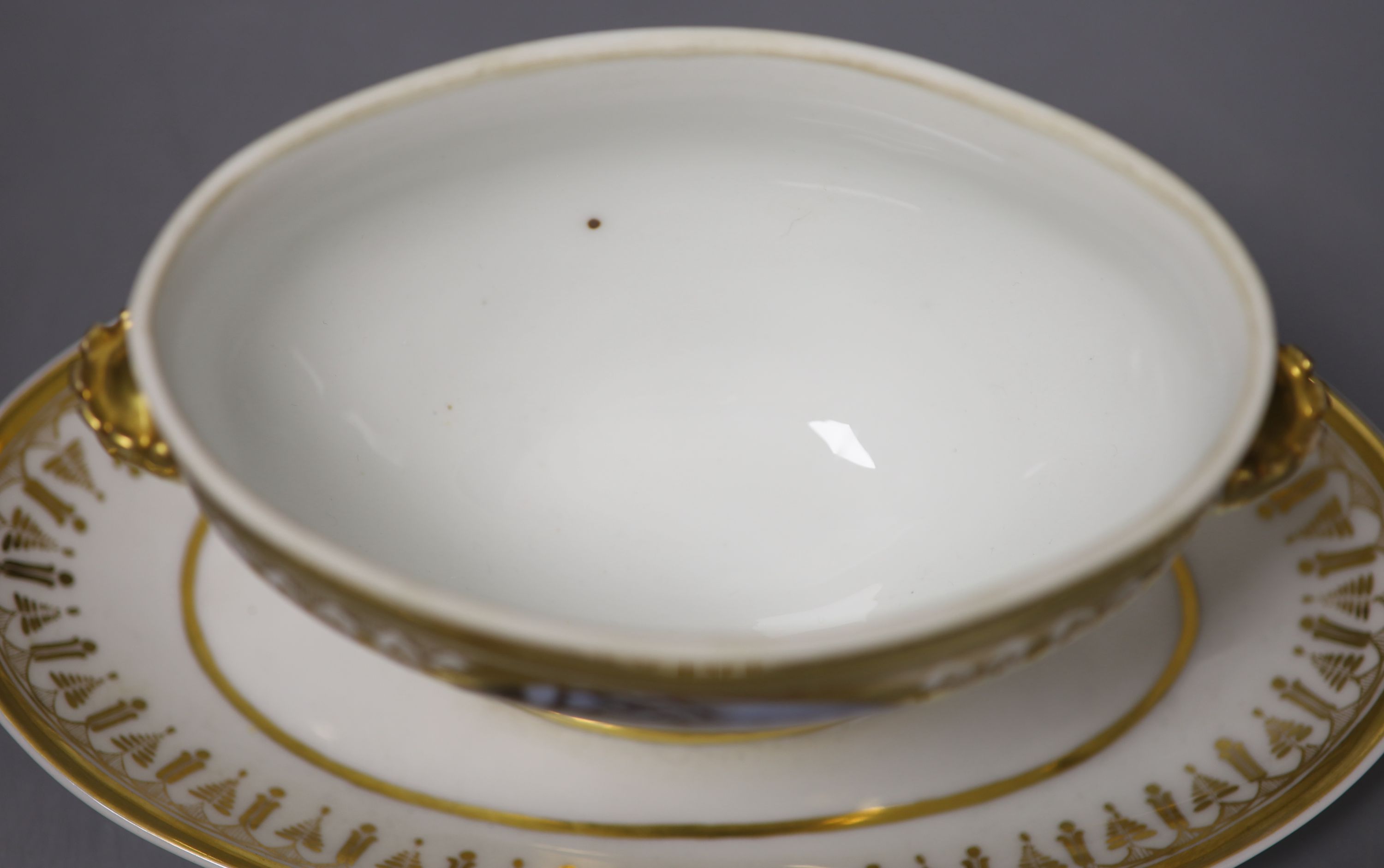 A Paris porcelain tureen and cover highly gilded and painted with four oval panels, two with dogs, one with a stag and one with two har